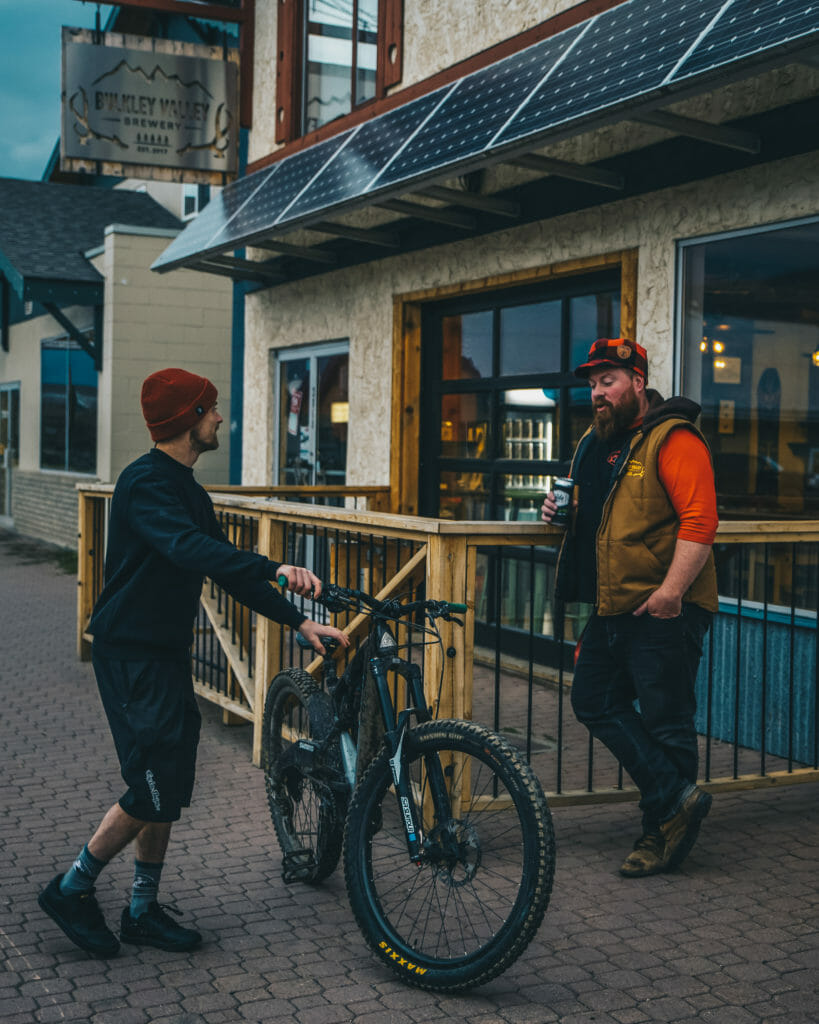 image of mountain biker, Mark Matthews, meeting Dave from Bulkley Valley Brewery at the brewery in Smiithers, BC
