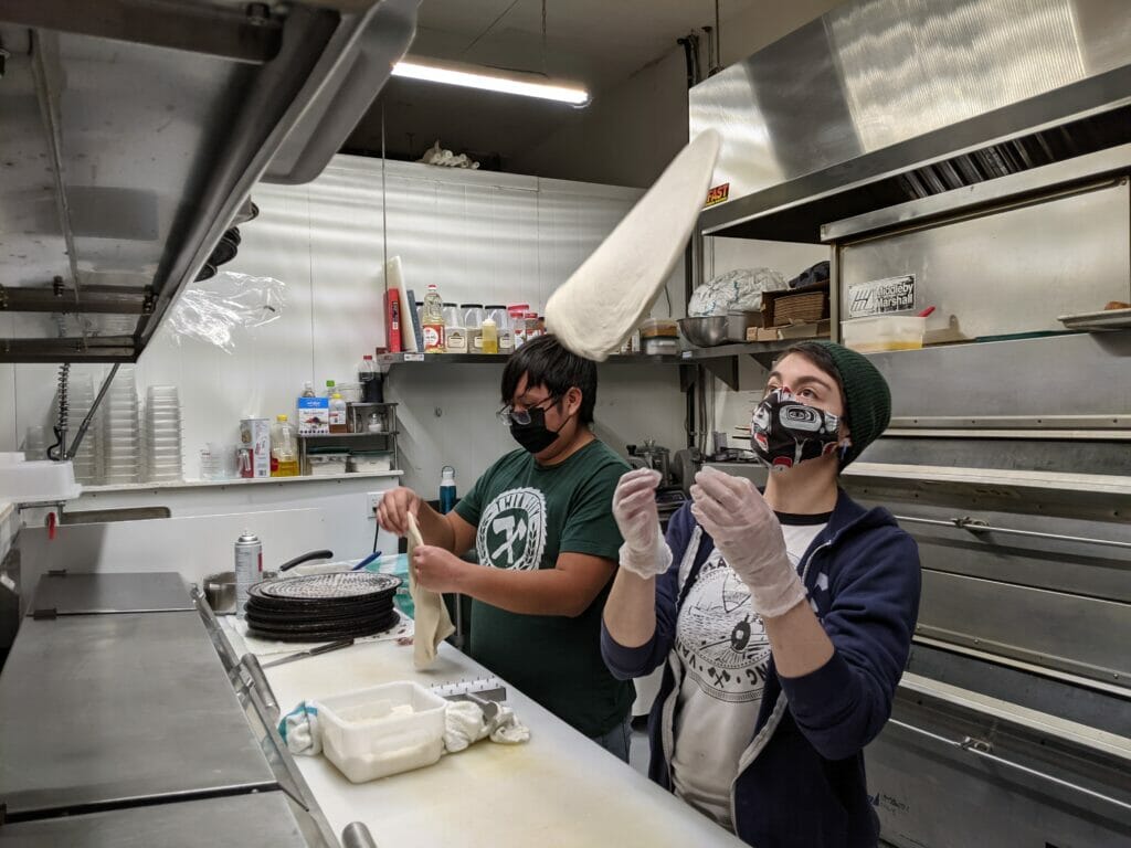 Flipping pizza dough at Twin City Berwing