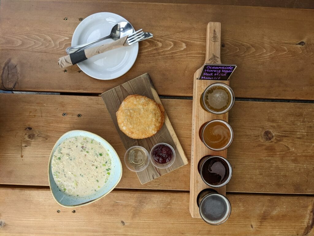 A bowl of chowder and a flight of beer at Fern + Cedar Brewing Co