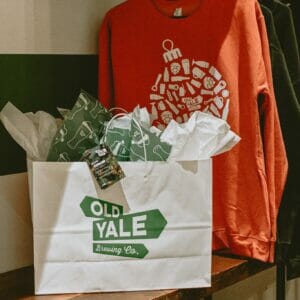 Pre-wrapped gift and Christmas sweater from Old Yale Brewing